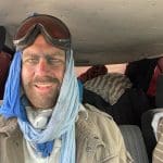 Wiebe Wakker in the taxi covered in dust after riding the Mauritanian iron ore train