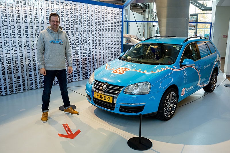 Wiebe Wakker with his blue bandit electric car in an exposition at the Autostadt Museum in Wolfsburg.